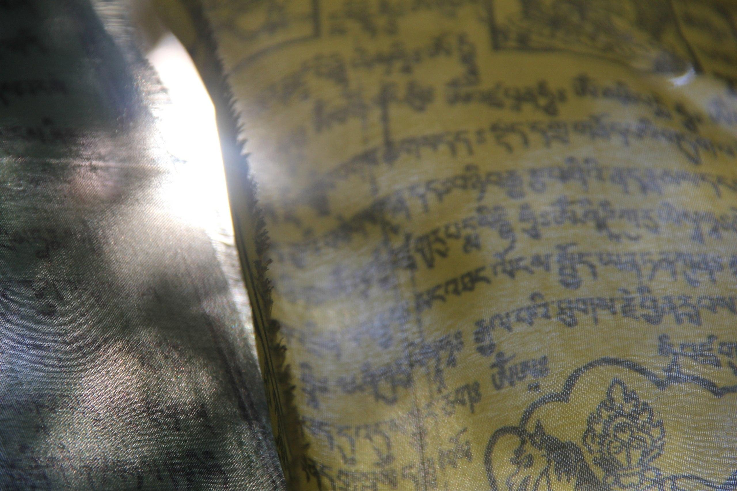 Sunlight passing through printed Bhutanese prayer flags