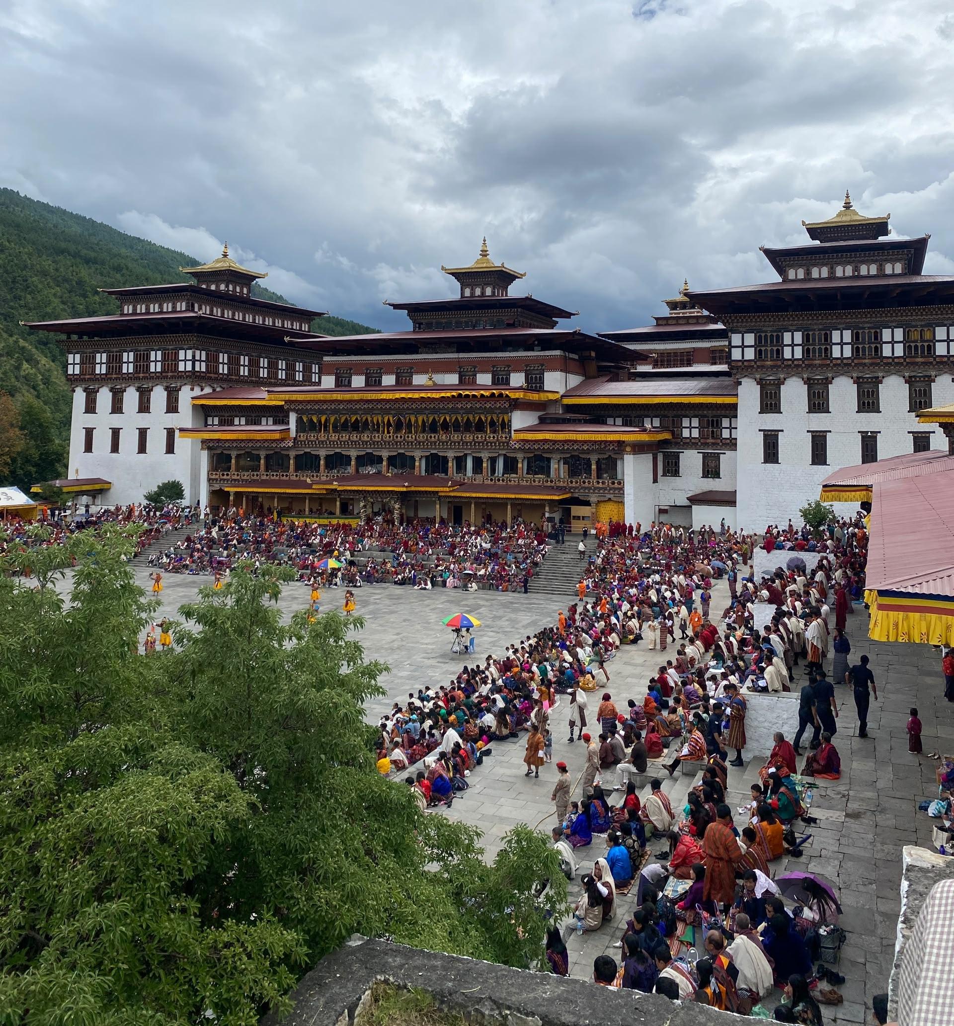A traditional festival gathering in the courtyard of Tashichho Dzong in Thimphu