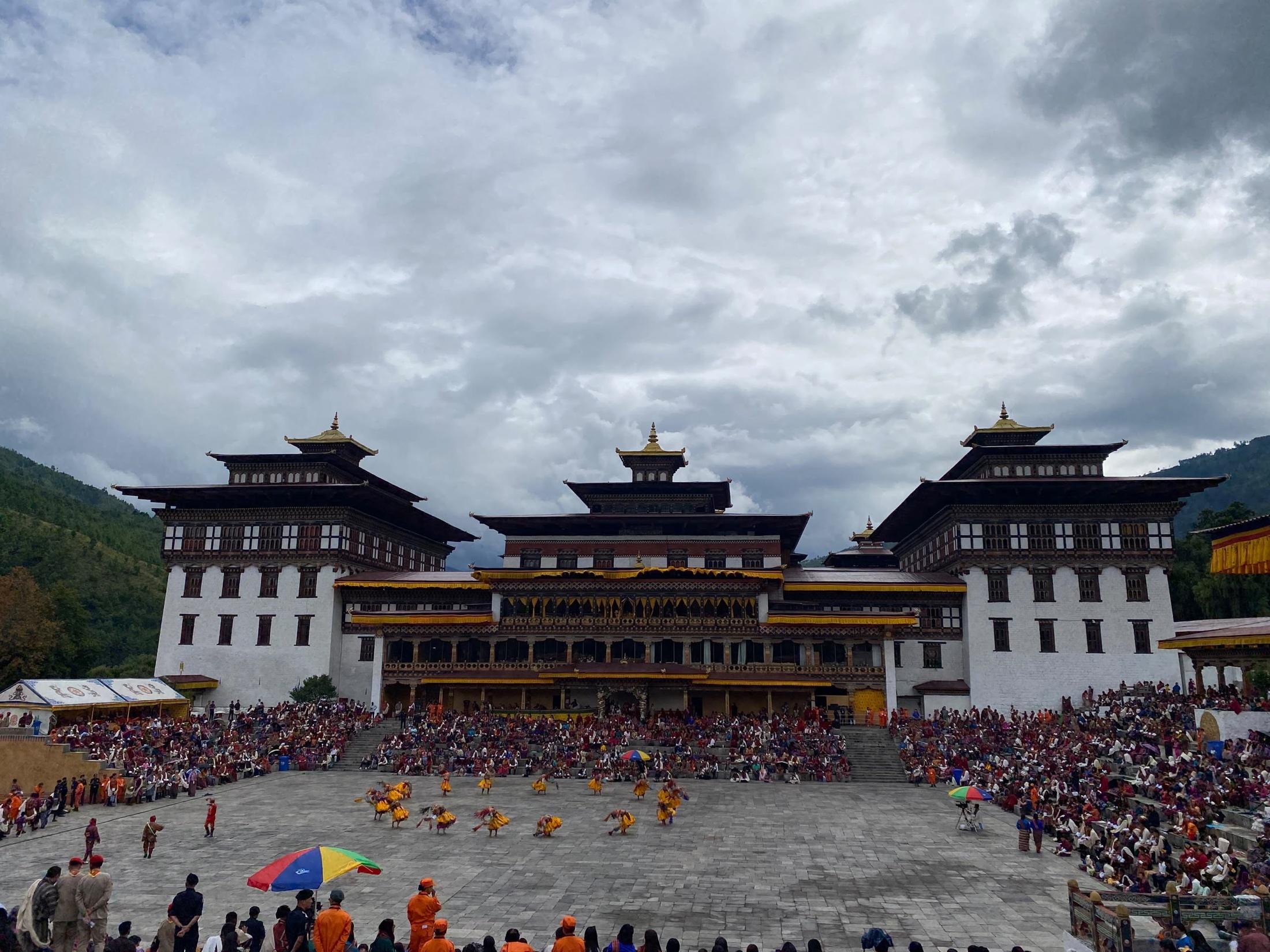 Masked dancers and visitors gathered at Tashichho Dzong